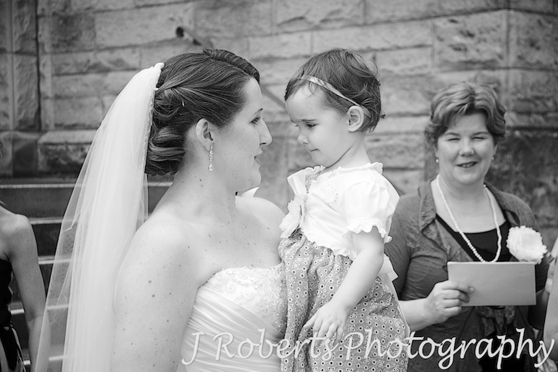 Bride chatting to little flower girl - wedding photography sydney